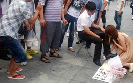 Nữ sinh xinh đẹp quỳ đánh giày giữa phố